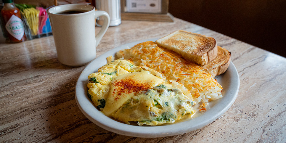 Sybil's Signature Omelette with hashbrowns, toast, and coffee